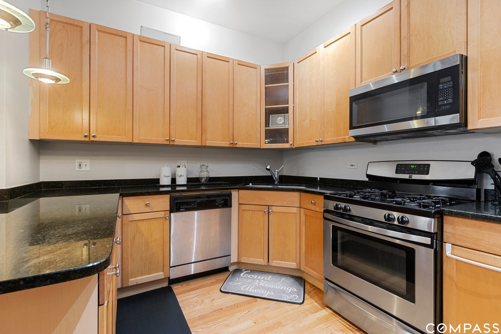2136 West Monroe Street, Unit 204 Chicago, IL 60612 - Photo 10 of 15 a kitchen with granite countertop a stove and a microwave