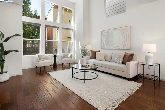 a living room with furniture a rug and a large window