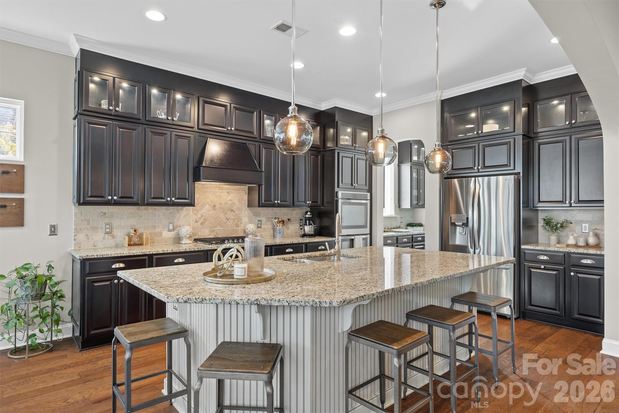 954 Castlewatch Drive Fort Mill, SC 29708 - Photo 11 of 45 a kitchen with stainless steel appliances granite countertop a sink wooden cabinets and a granite counter tops