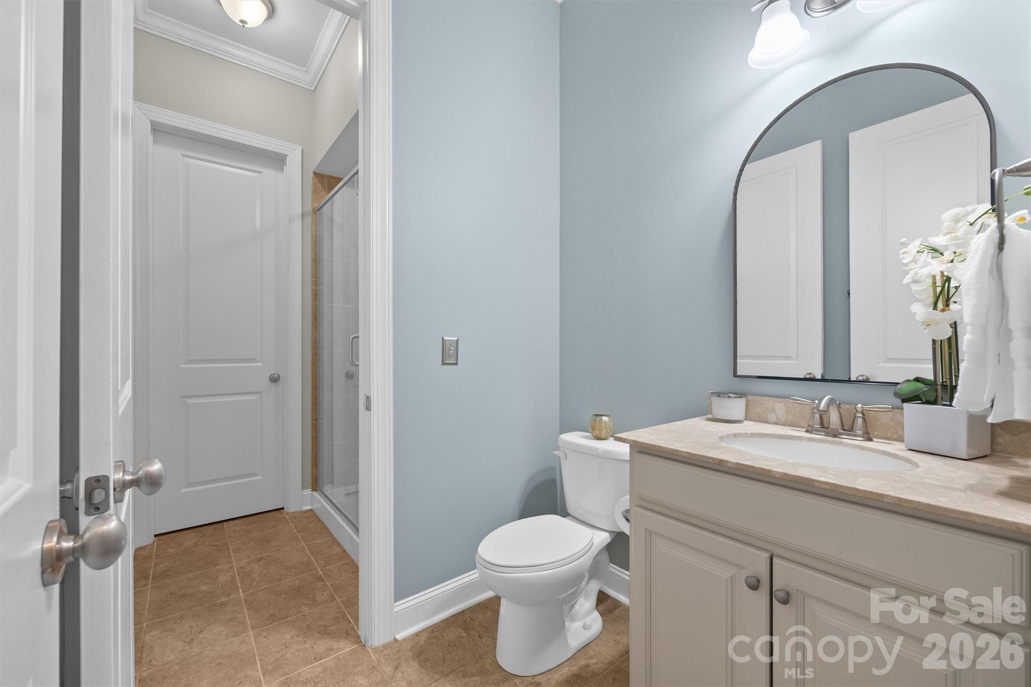 954 Castlewatch Drive Fort Mill, SC 29708 - Photo 17 of 45 a bathroom with a granite countertop toilet a sink and a mirror
