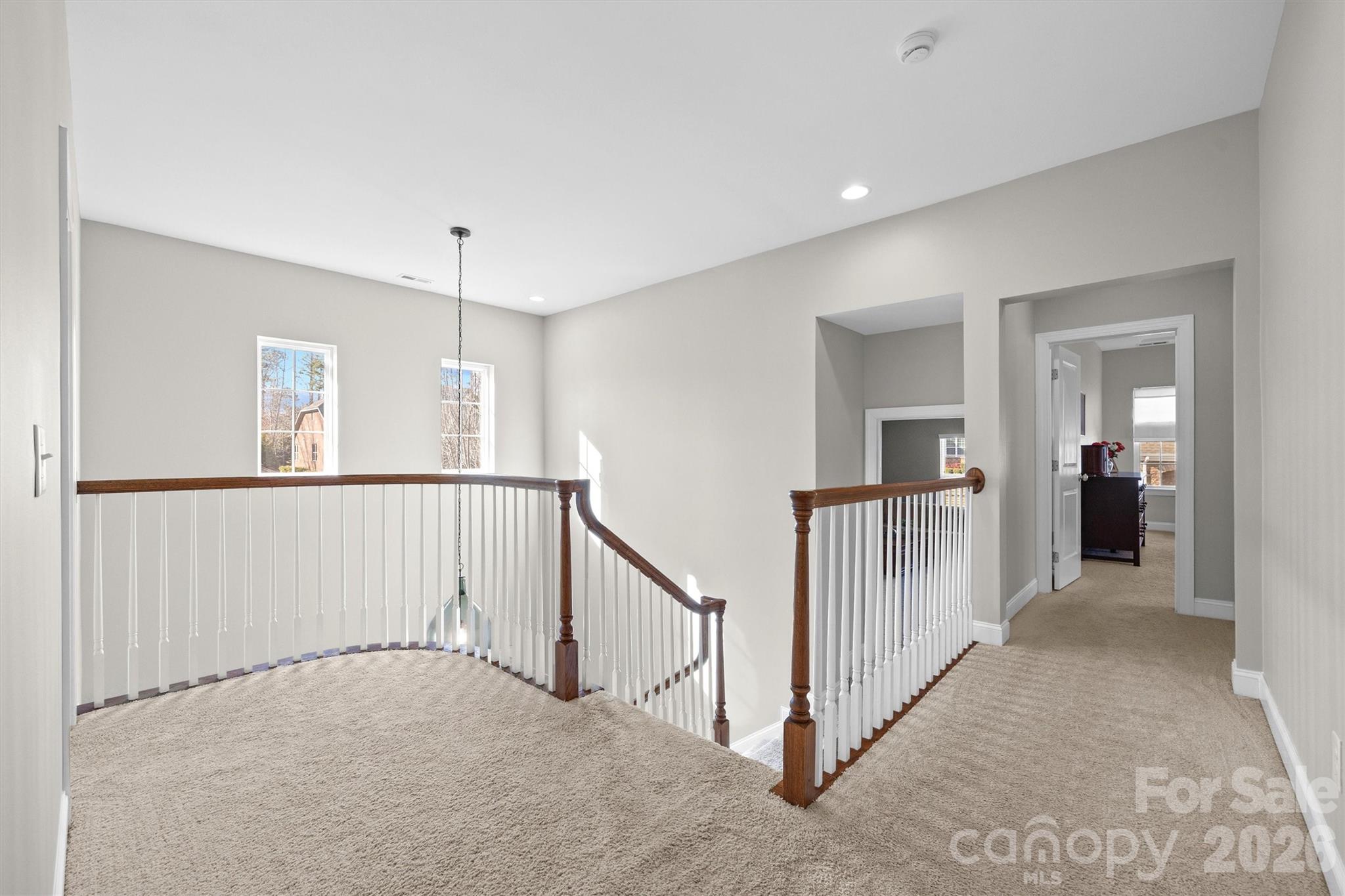 954 Castlewatch Drive Fort Mill, SC 29708 - Photo 18 of 45 a view of a hallway with a chandelier fan