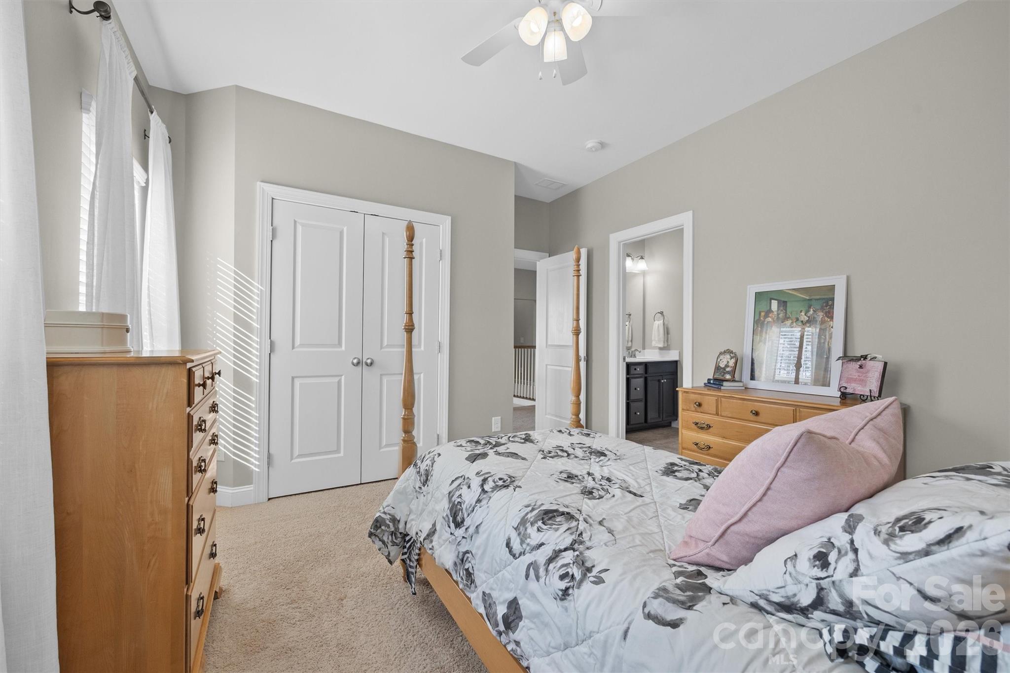 954 Castlewatch Drive Fort Mill, SC 29708 - Photo 27 of 45 a bedroom with a bed and a chandelier