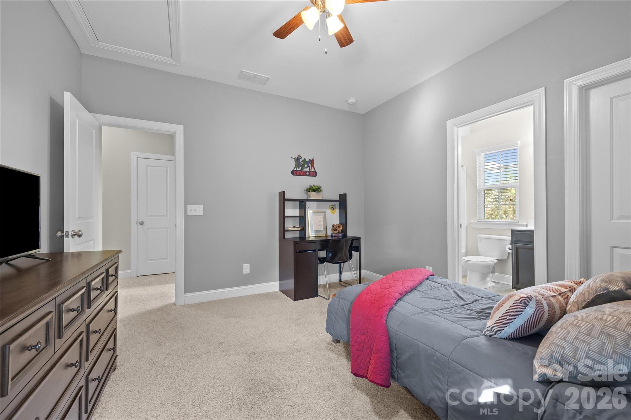 954 Castlewatch Drive Fort Mill, SC 29708 - Photo 33 of 45 a bedroom with a bed and a flat tv screen on a dresser
