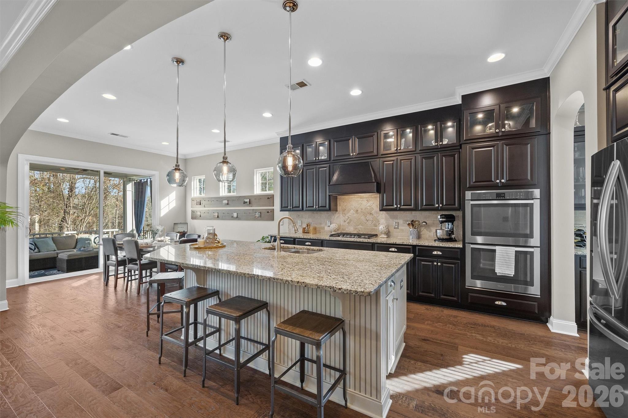 954 Castlewatch Drive Fort Mill, SC 29708 - Photo 10 of 45 a kitchen with stainless steel appliances granite countertop a stove top oven a sink island and a refrigerator