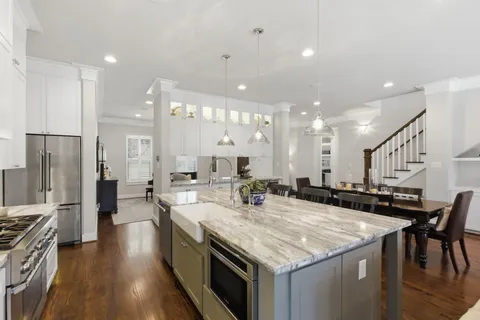 a kitchen with stainless steel appliances granite countertop lots of counter top space and refrigerator