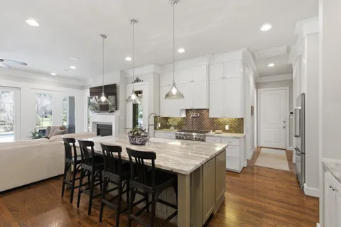 a large kitchen with a table and chairs