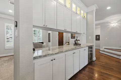 a kitchen with stainless steel appliances granite countertop a sink and a white cabinets