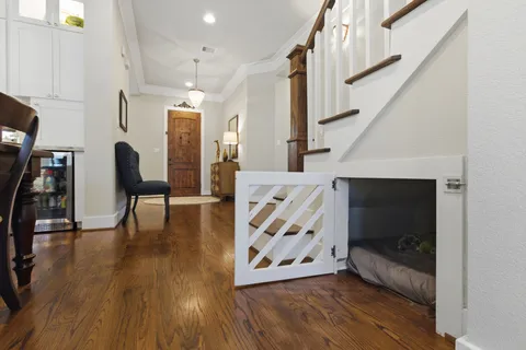 a view of an entryway with wooden floor and door