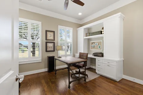 a view of a workspace with furniture and a window