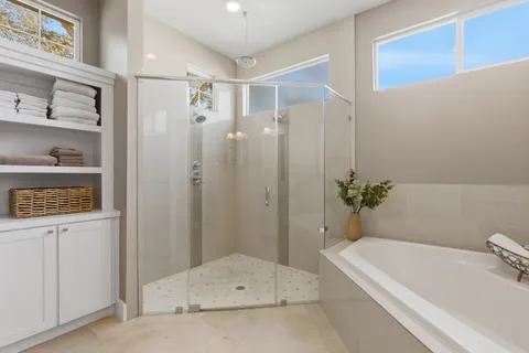 a bathroom with a tub shower and a sink