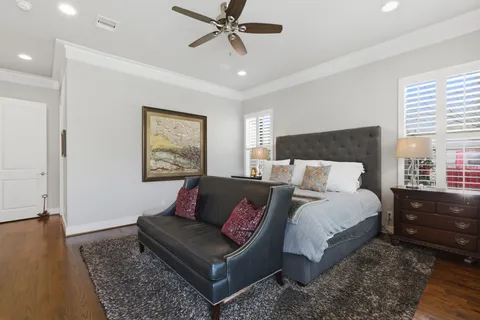 a bedroom with bed and wooden floor