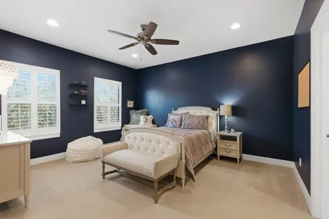 a spacious bedroom with a bed and a large window