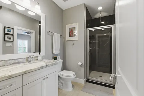 a bathroom with a toilet a sink and shower