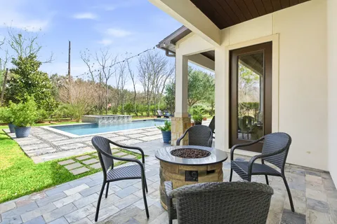 a view of a patio with table and chairs and potted plants