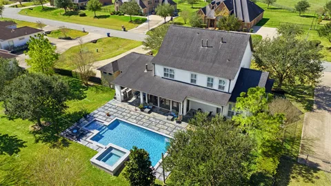 an aerial view of residential house with outdoor space and swimming pool