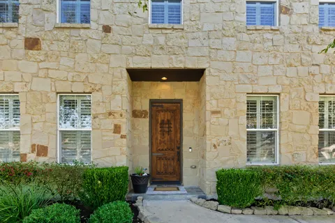 a front view of a house with a garden
