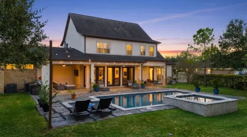 a view of a house with backyard and sitting area