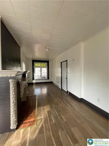 a view of livingroom with hardwood floor and a flat screen tv