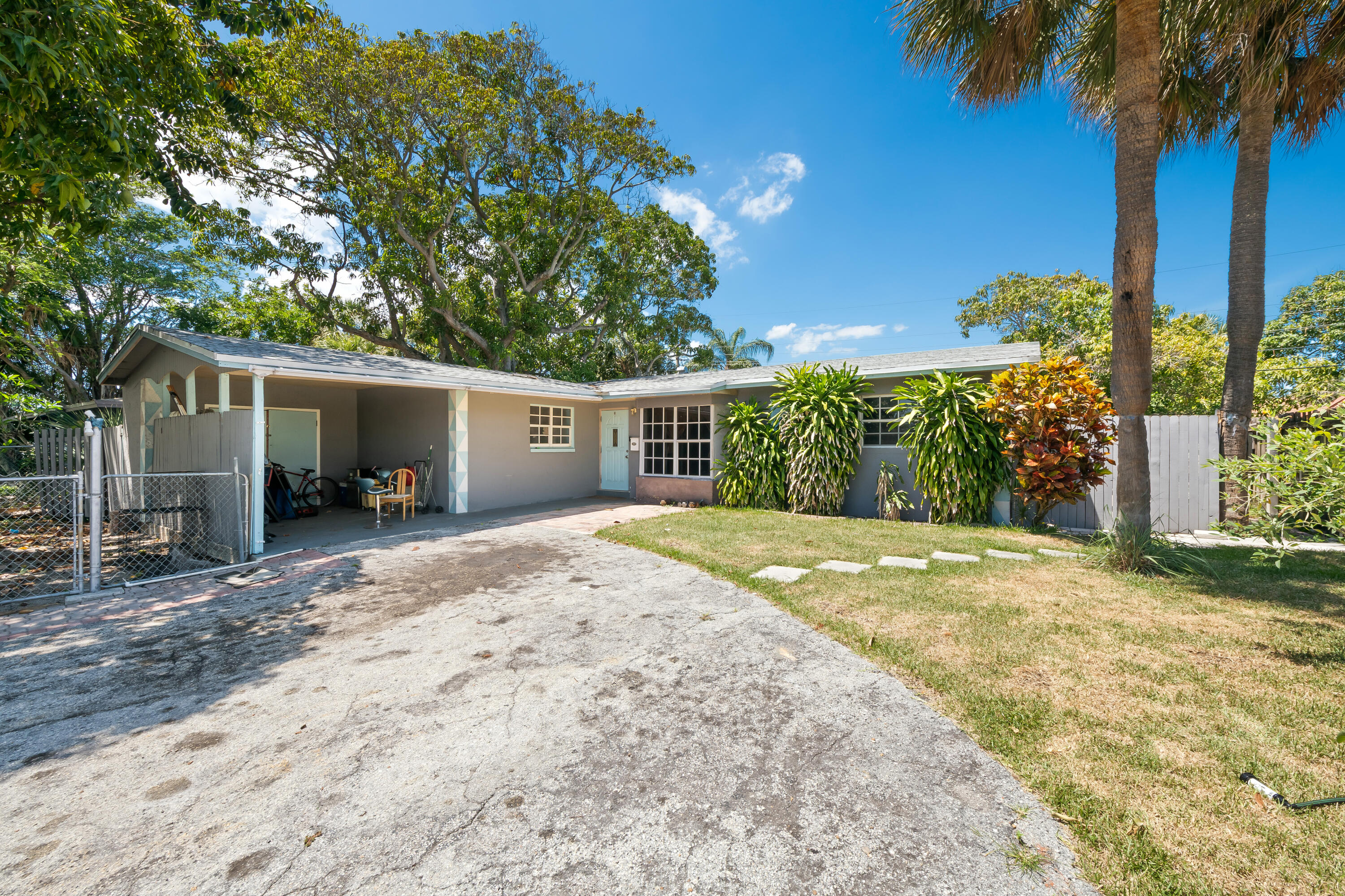 101 Northwest 18th Street Pompano Beach, FL 33060 - Photo 1 of 23 front view of a house with a yard and potted plants