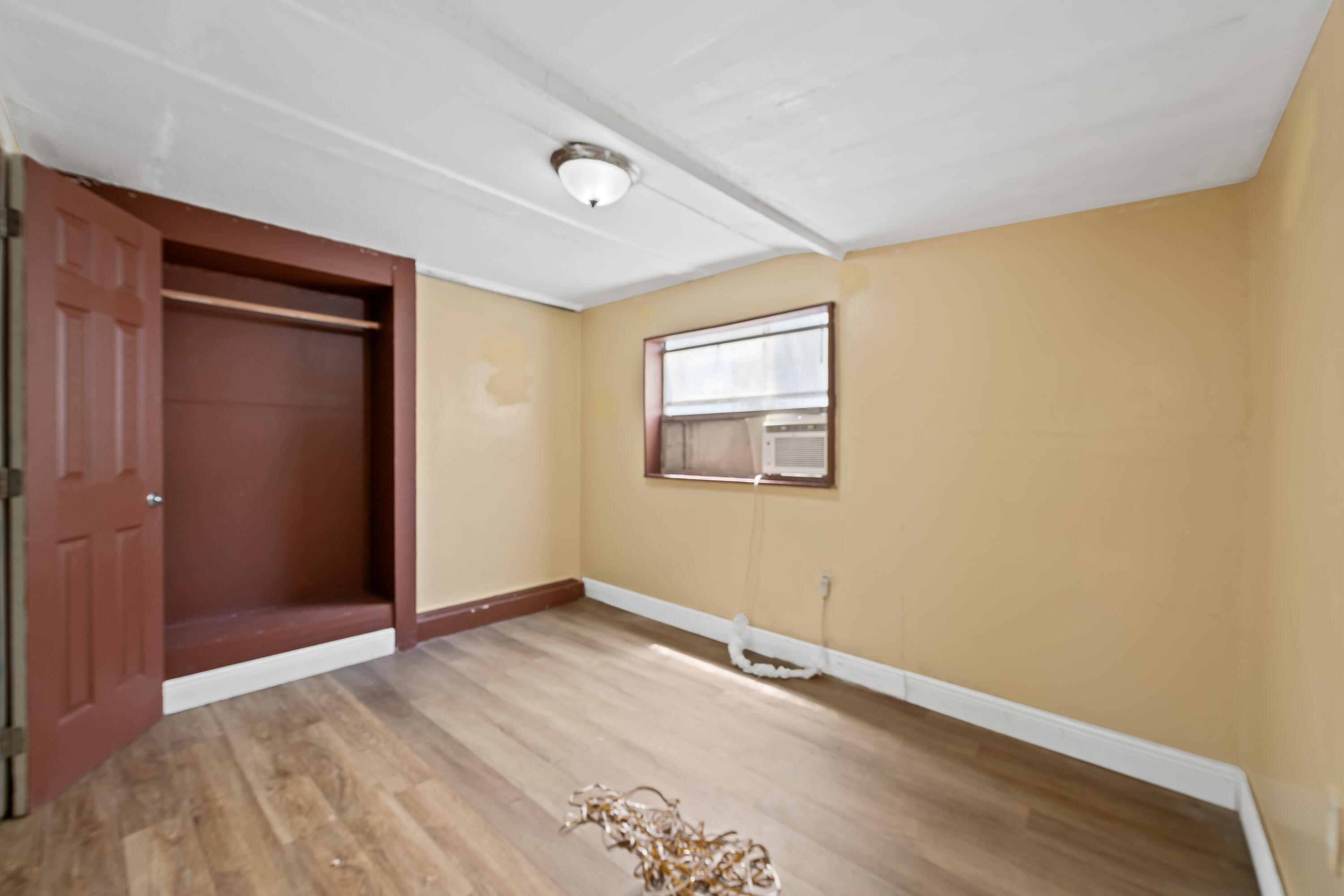 101 Northwest 18th Street Pompano Beach, FL 33060 - Photo 20 of 23 an empty room with wooden floor and windows
