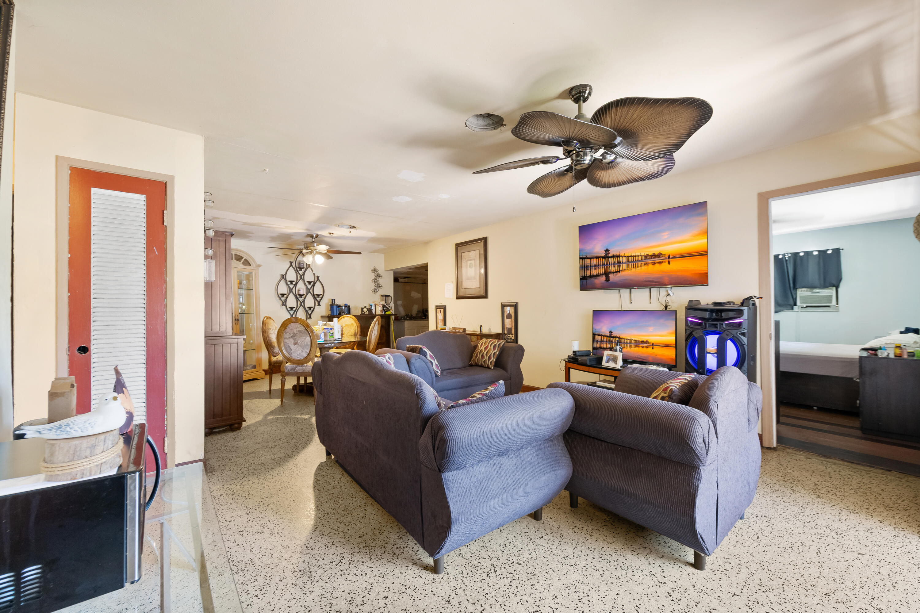 101 Northwest 18th Street Pompano Beach, FL 33060 - Photo 3 of 23 a living room with furniture a ceiling fan and a rug