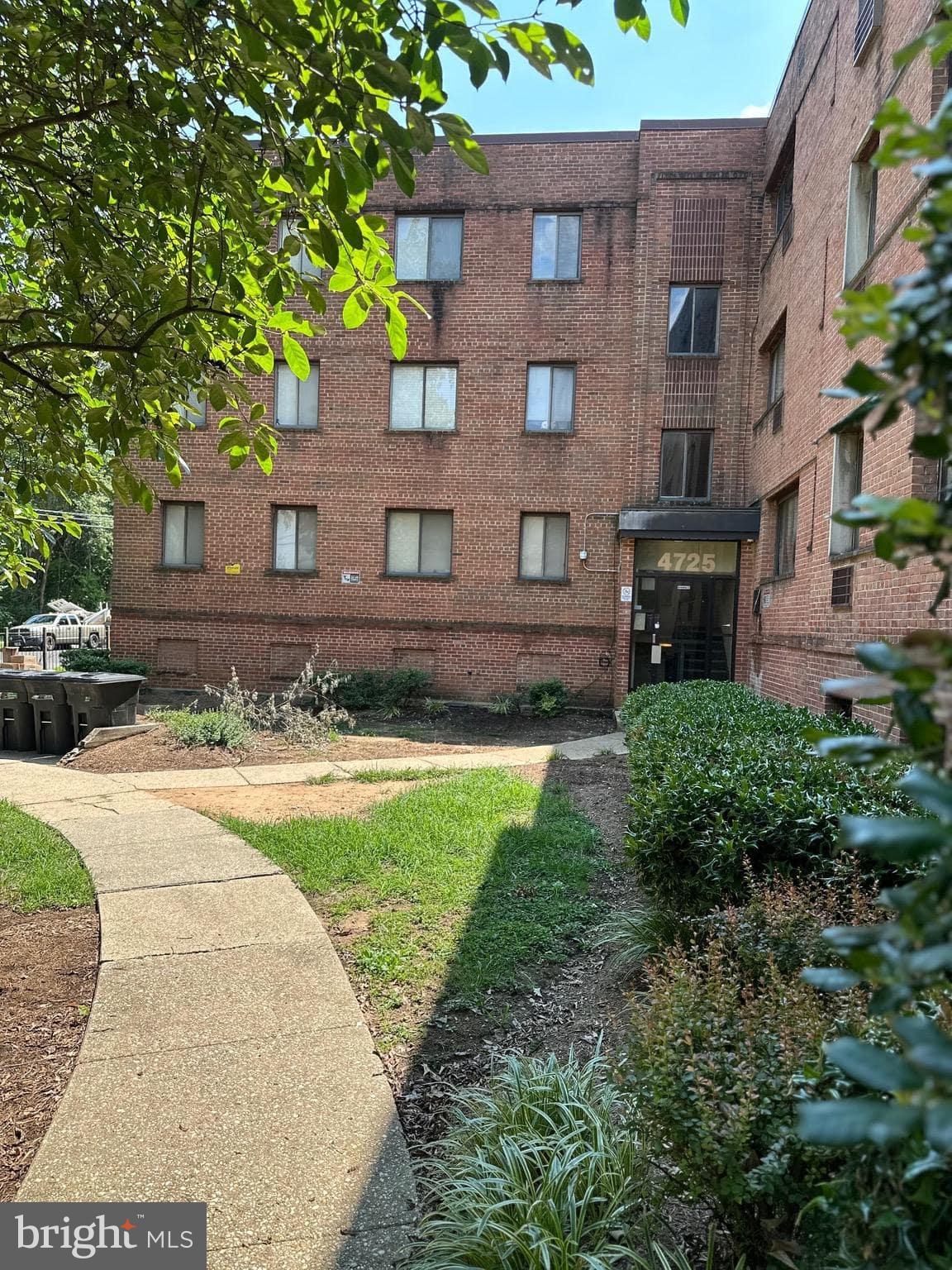 4725 1st Street Southwest, Unit 303 Washington, DC 20032 - Photo 6 of 17 a view of a brick building next to a yard