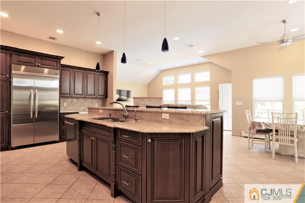 18 Homestead Road Freehold, NJ 07728 - Photo 14 of 32 a kitchen with a sink and a refrigerator