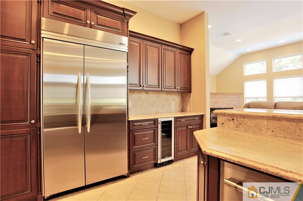 18 Homestead Road Freehold, NJ 07728 - Photo 15 of 32 a kitchen with a refrigerator and a stove top oven