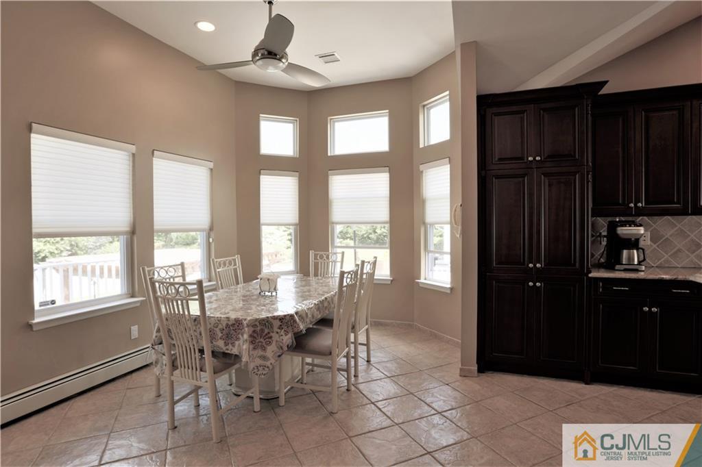18 Homestead Road Freehold, NJ 07728 - Photo 18 of 32 a dining room with furniture a chandelier and wooden floor