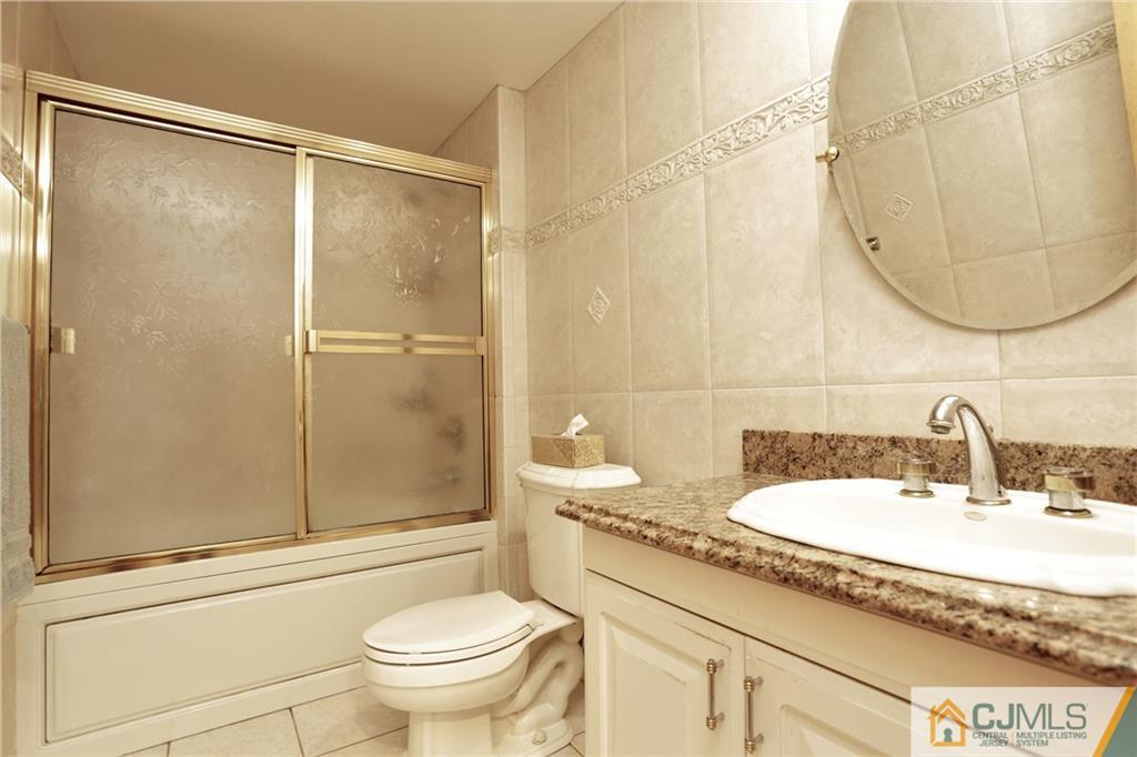 18 Homestead Road Freehold, NJ 07728 - Photo 23 of 32 a bathroom with a granite countertop sink toilet and shower