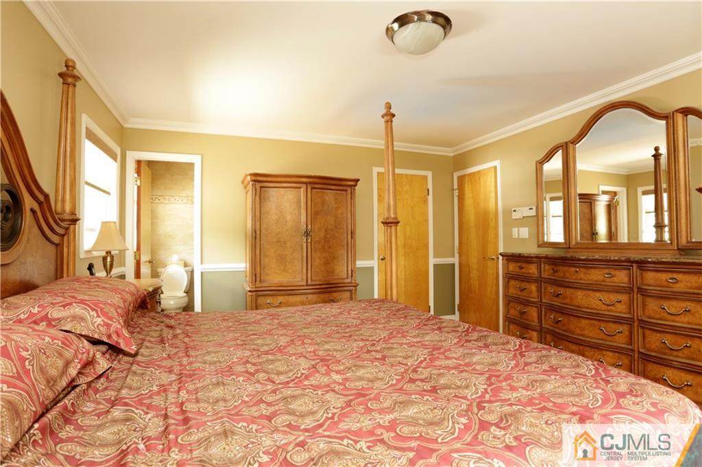 18 Homestead Road Freehold, NJ 07728 - Photo 26 of 32 a bedroom with a bed and wooden floor