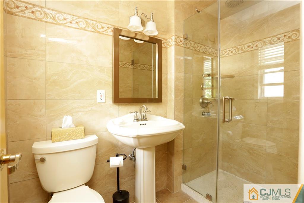 18 Homestead Road Freehold, NJ 07728 - Photo 27 of 32 a bathroom with a toilet sink and shower