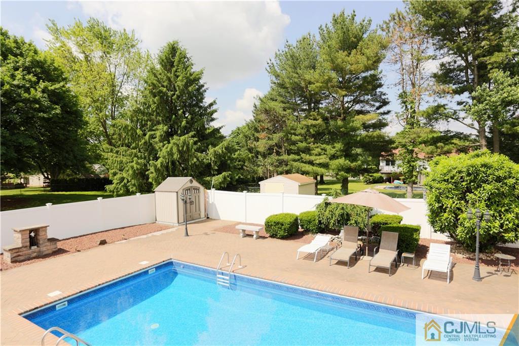 18 Homestead Road Freehold, NJ 07728 - Photo 28 of 32 a view of backyard with a table and chairs