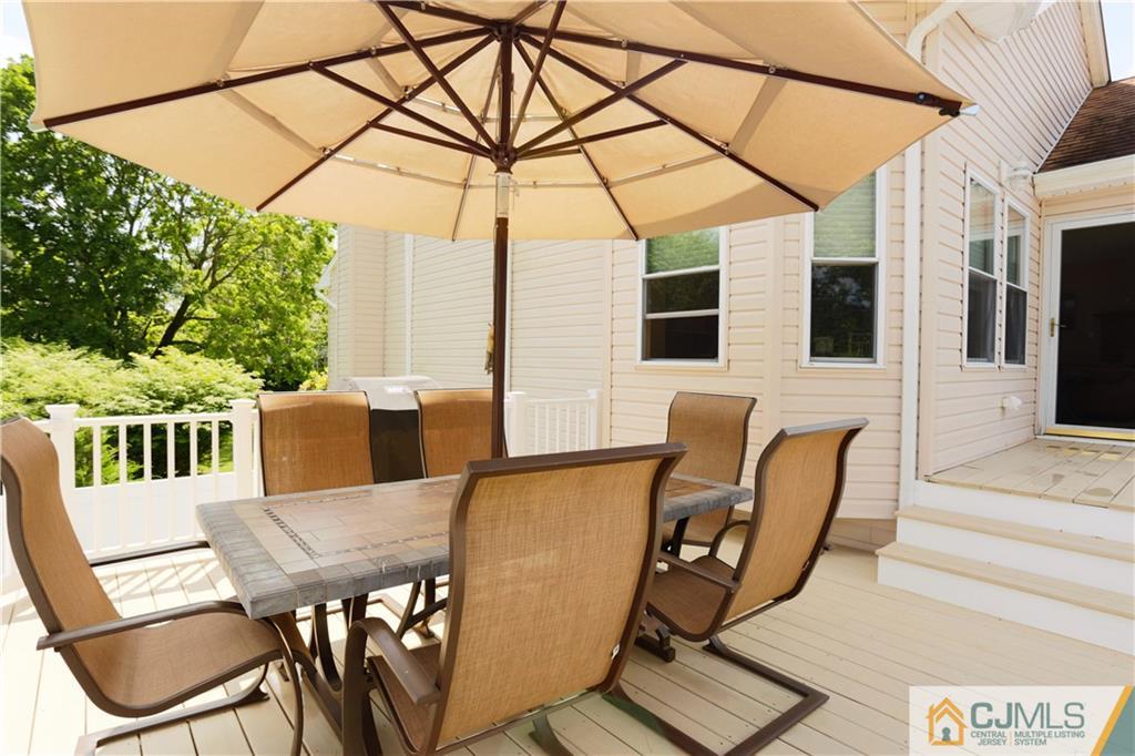 18 Homestead Road Freehold, NJ 07728 - Photo 29 of 32 a view of a patio with table and chairs and wooden floor