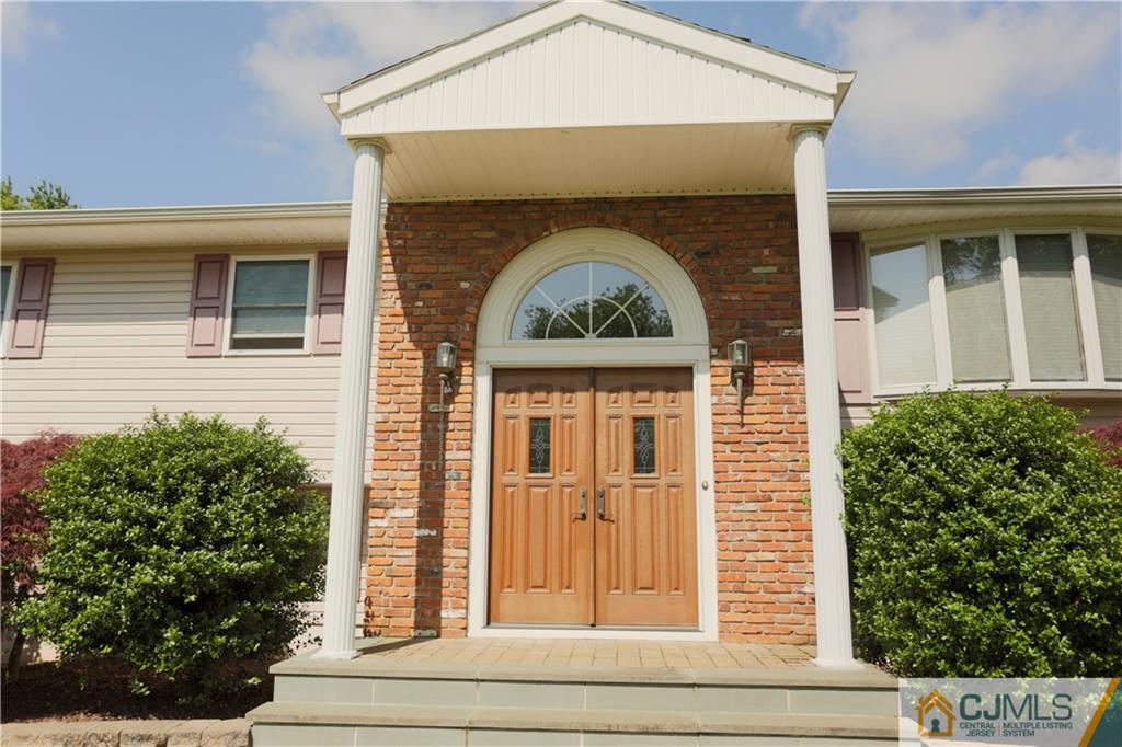 18 Homestead Road Freehold, NJ 07728 - Photo 4 of 32 a front view of a house with plants