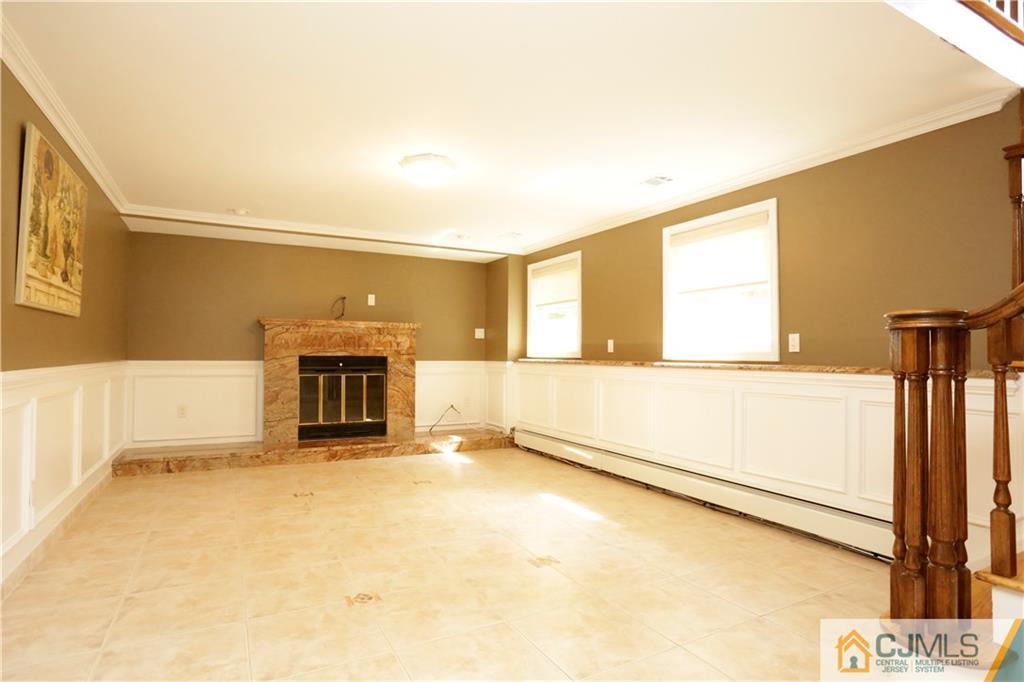 18 Homestead Road Freehold, NJ 07728 - Photo 5 of 32 a view of an empty room with a fireplace and a window