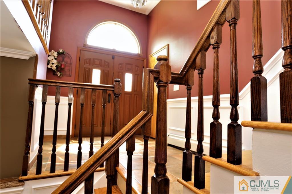 18 Homestead Road Freehold, NJ 07728 - Photo 10 of 32 a view of staircase with railing and a chandelier
