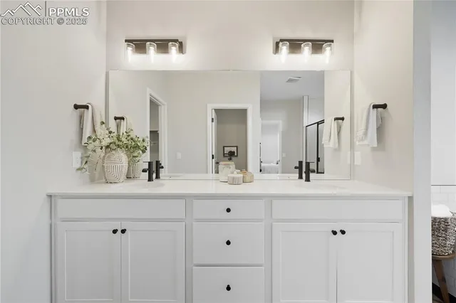 a bathroom with double sink and a mirror