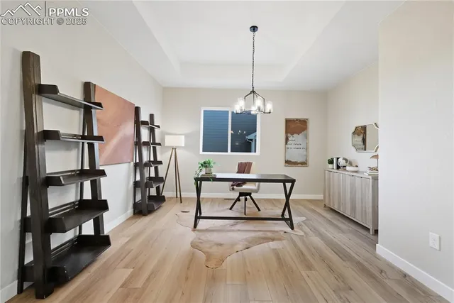 a view of a room with furniture and wooden floor