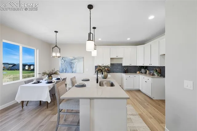 a kitchen with counter space appliances and a chair
