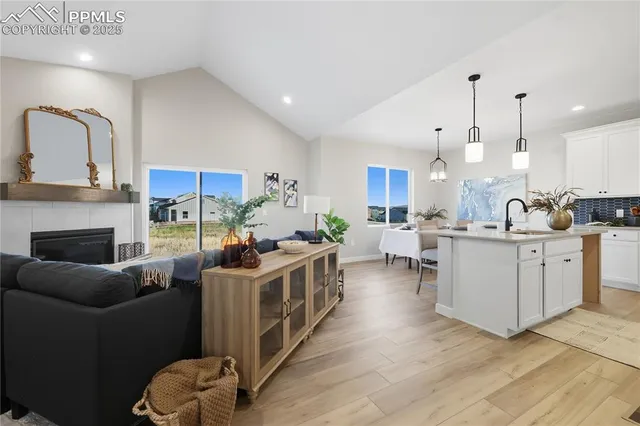 a kitchen with stainless steel appliances granite countertop a stove and a wooden floors