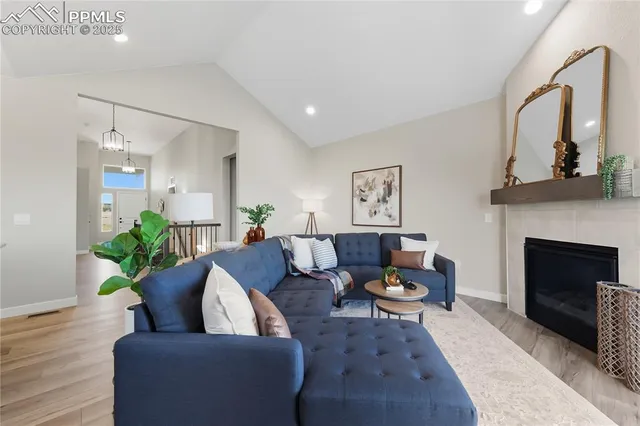 a living room with furniture and a fireplace