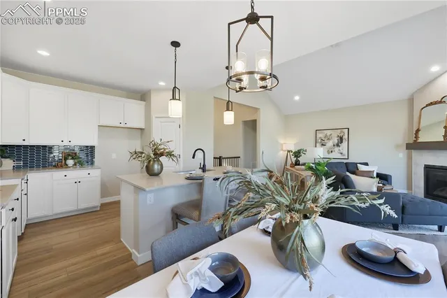 a view of a kitchen and dining room with wooden floor