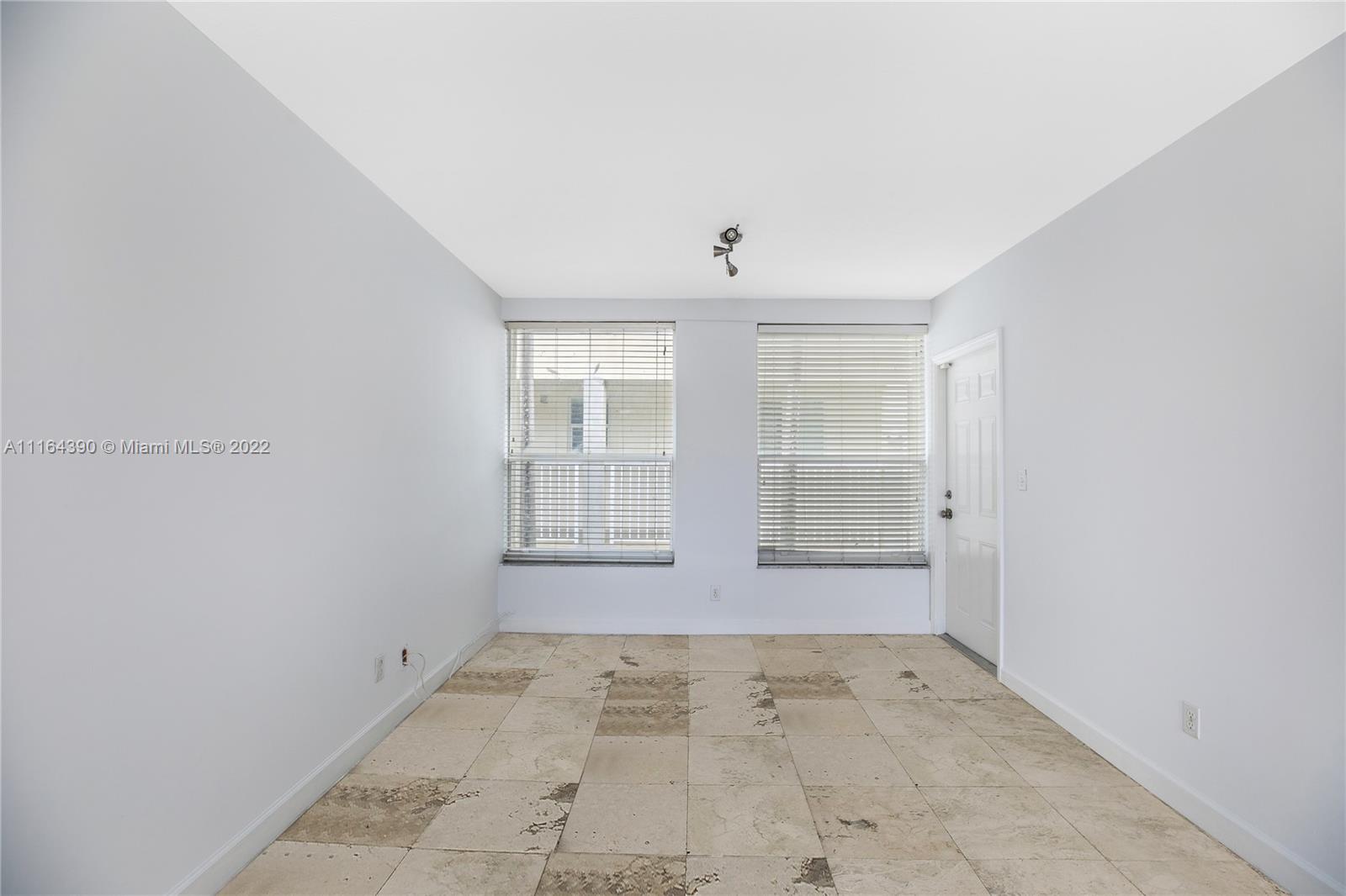 1025 Southwest 7th Avenue, Unit 9 Miami, FL 33129 - Photo 4 of 9 an empty room with windows
