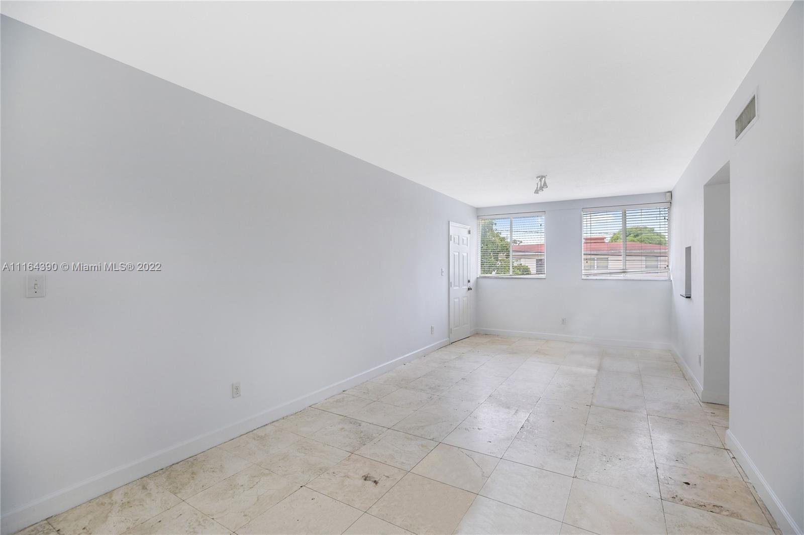 1025 Southwest 7th Avenue, Unit 9 Miami, FL 33129 - Photo 7 of 9 an empty room with windows