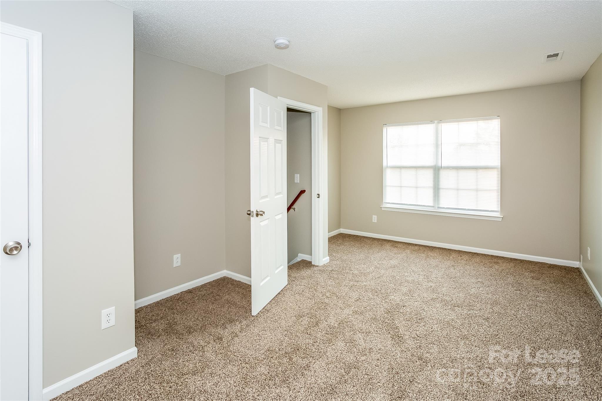 6131 Sid Crane Drive Charlotte, NC 28216 - Photo 15 of 17 an empty room with windows