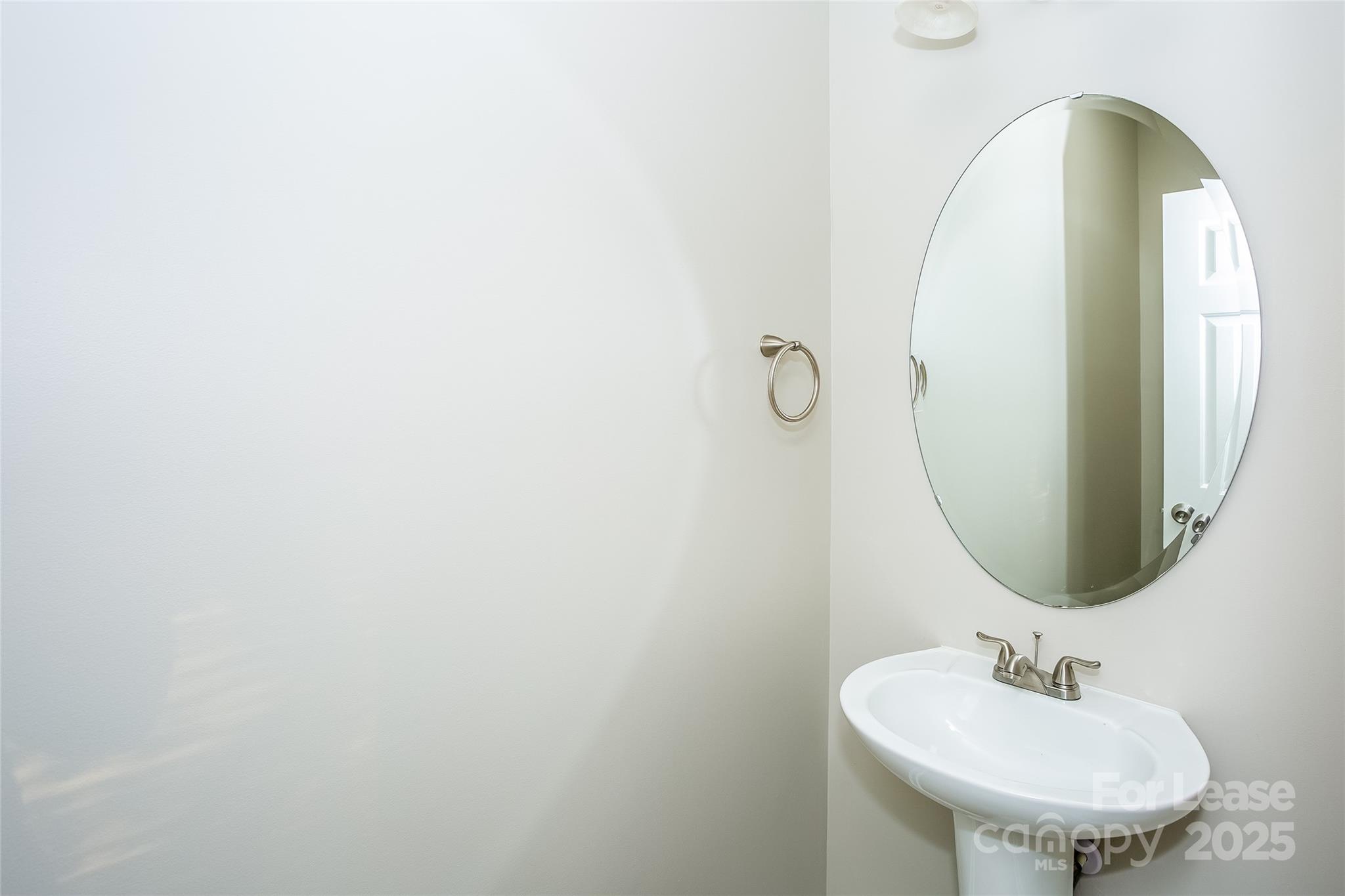 6131 Sid Crane Drive Charlotte, NC 28216 - Photo 16 of 17 a bathroom with a sink and a mirror