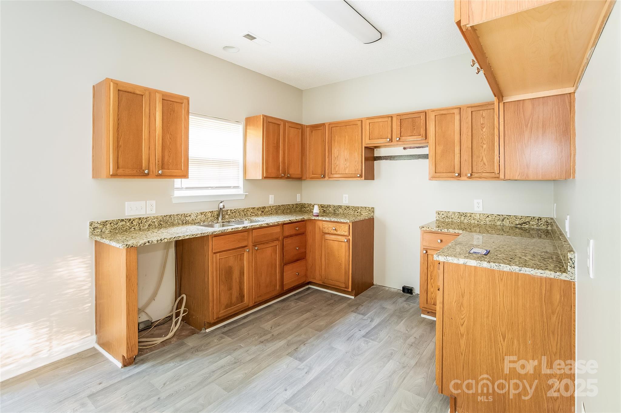 6131 Sid Crane Drive Charlotte, NC 28216 - Photo 7 of 17 a kitchen with a stove top oven sink and cabinets