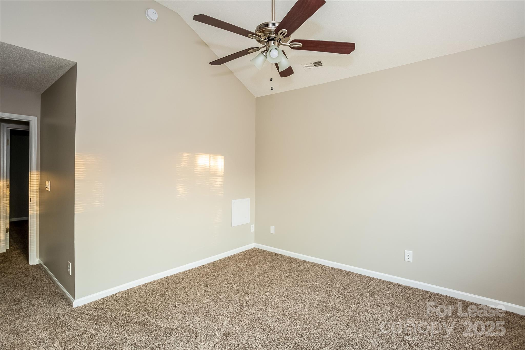 6131 Sid Crane Drive Charlotte, NC 28216 - Photo 9 of 17 an empty room with a fan & a ceiling fan