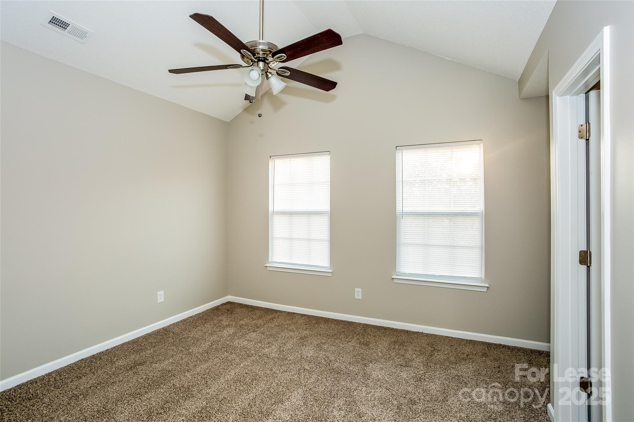 6131 Sid Crane Drive Charlotte, NC 28216 - Photo 10 of 17 an empty room with windows and fan